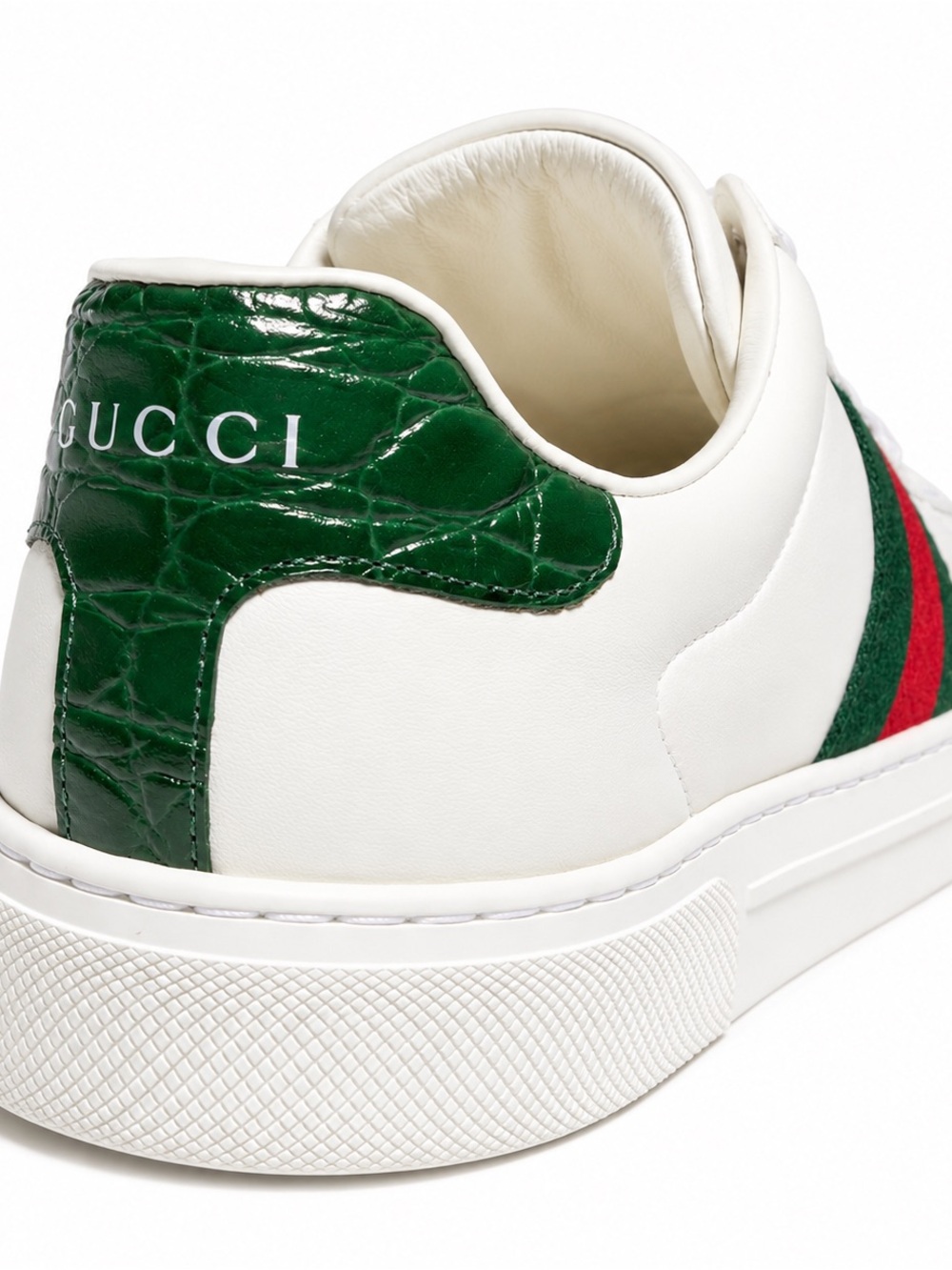 Gucci Ace sneakers with a distinct metal ACE tag on the lace-up closure